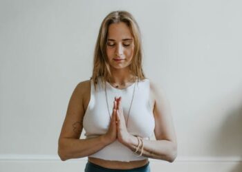 Mujer practicando yoga en una habitación luminosa